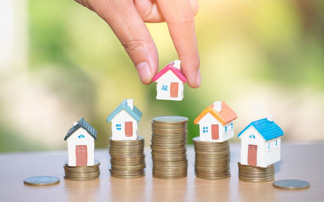 Mini house on stack of coins, Real estate investment